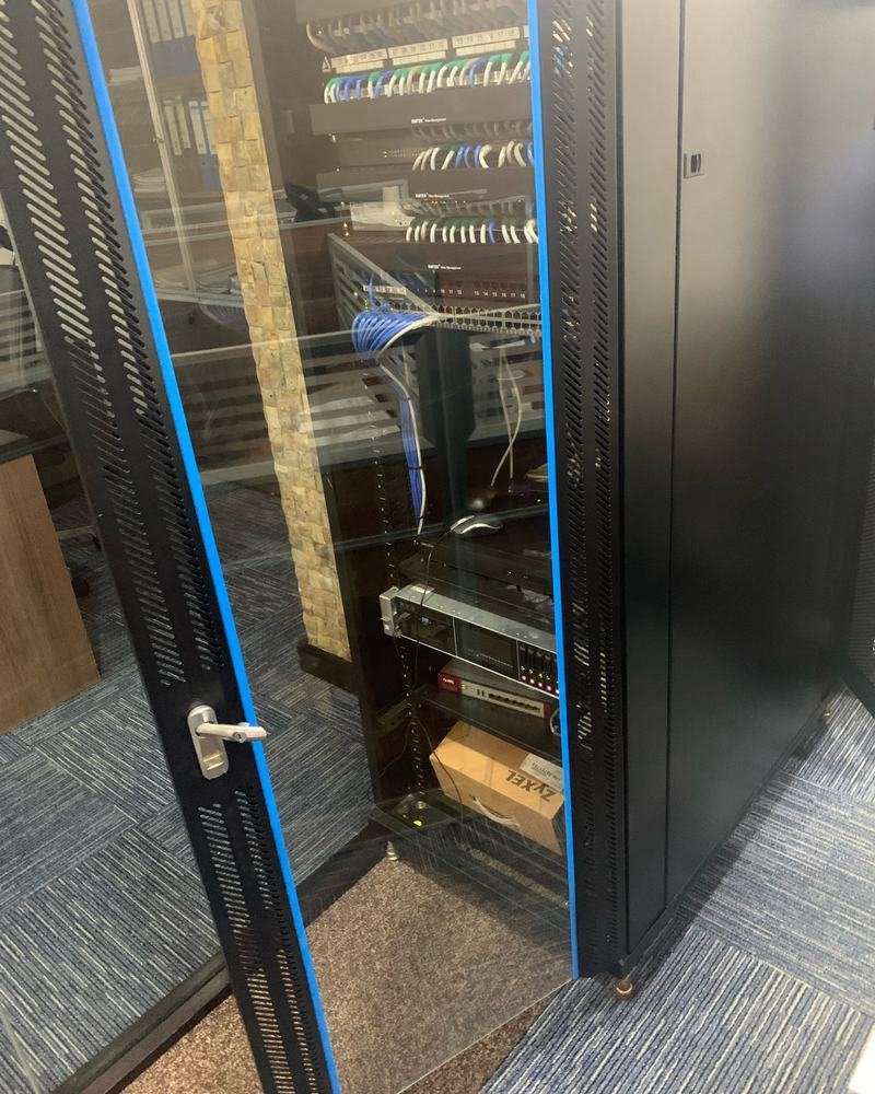 A finished server cabinet with patch panels and switches