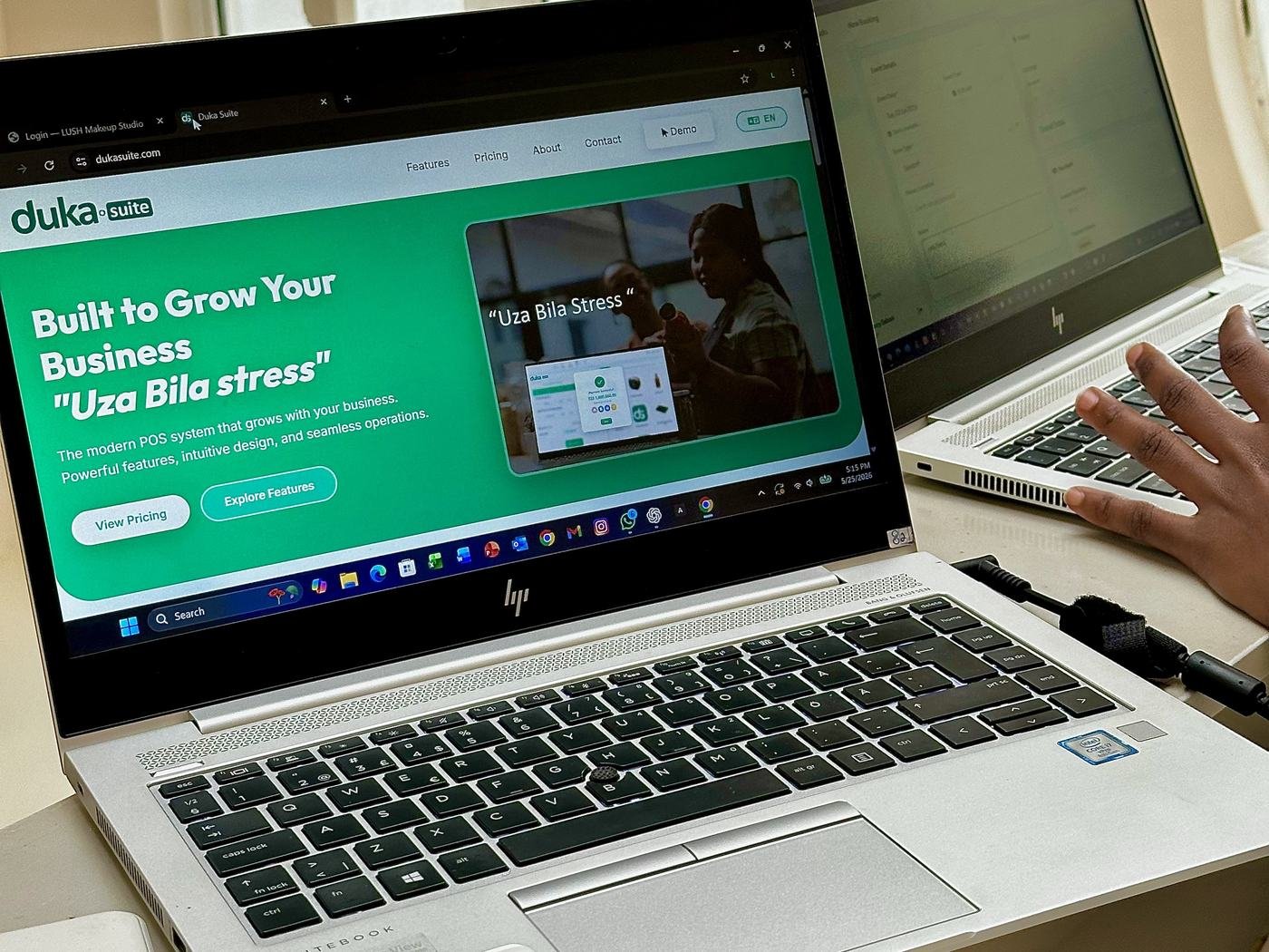 A laptop showing DukaSuite, Built to Grow Your Business, Uza Bila stress